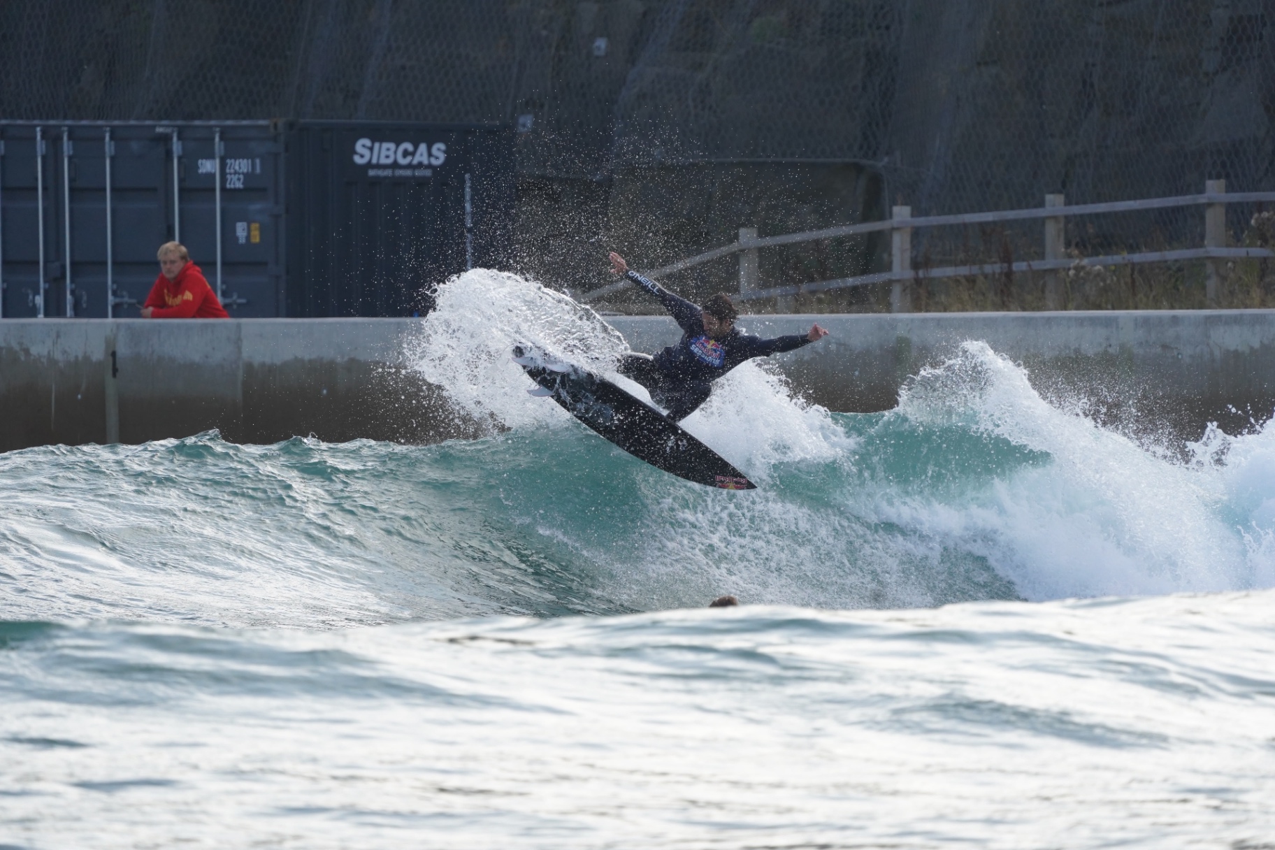 Surfer throwing a wall of spray off the lip at Lost Shore Surf Resort